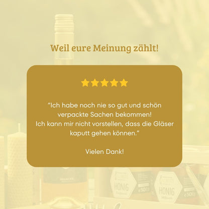 5-Sterne-Kundenbewertung zur sicheren und schönen Verpackung der Goldnote Honig-Finder Box mit Honiggläsern im Hintergrund